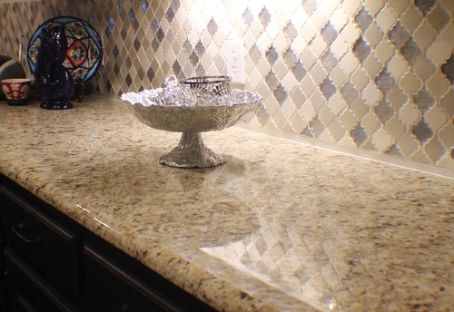 Giallo Ornamental Granite Countertop with Glazed Ceramic Beveled Arabesque Tile and Capuccino Kitchen Cabinets